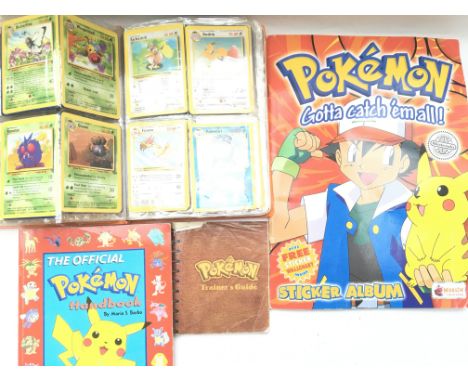 A collection of Pokemon cards in official folder with sticker book, handbook and trainer guide.