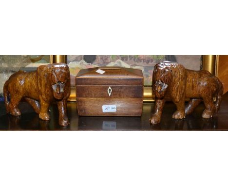 A pair of carved oak lions and a 19th century mahogany and satin wood inlaid tea caddy
