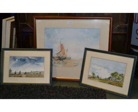 A watercolour seascape of boats on a beach with two other landscape watercolours