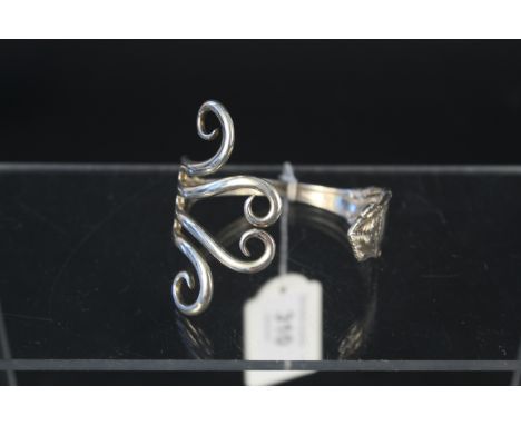 A sterling silver bangle made from a fork