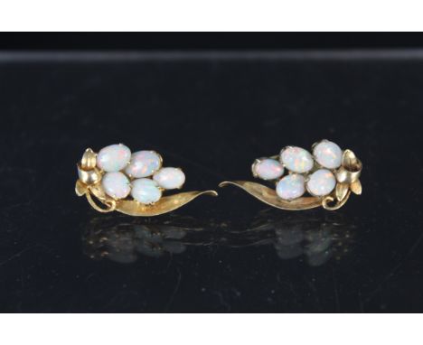 A pair of yellow metal floral spray earrings, each set with five oval opal stones, clip on backs (one stamped 14K)