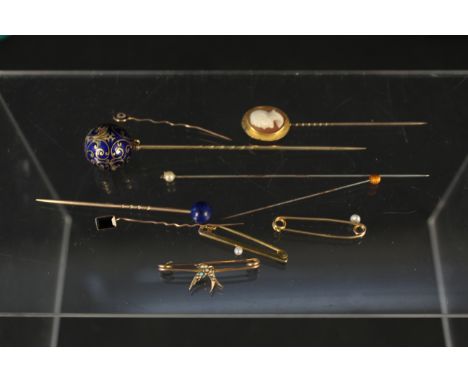 A collection of 9ct gold and yellow metal brooches and pins including three small 9ct gold bar brooches (one as found), a car