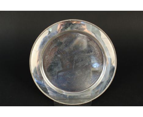 A silver Stuart Devlin plate with engraved horse racing scene entitled ''Pawneese 1976'', in original box, approx 338g