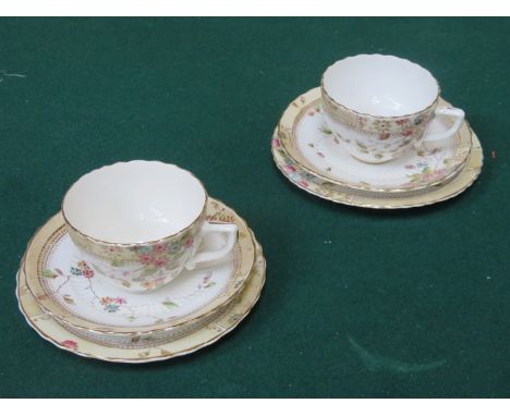 PAIR OF VICTORIAN STYLE FLORAL DECORATED AND GILDED CERAMIC TRIOS 