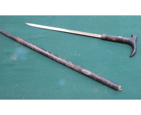 CARVED EBONISED AND BRASS MOUNTED SWORD STICK 