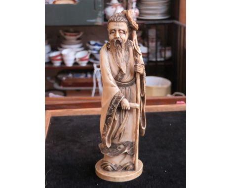 19th CENTURY ORIENTAL STYLE IVORY FIGURE OF A GENT WITH STAFF, SIGNED TO BASE, APPROXIMATELY 20cm HIGH 