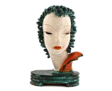 A Goldscheider pottery free-standing bust of a lady,no. 6887, modelled with curled turquoise hair, pierced eyes, orange lips 