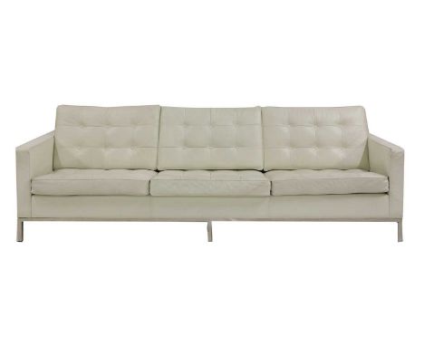 A modern 'Relax'-style white leather sofa, in the manner of Florence Knoll, with a buttoned back and seat cushions, on a chro