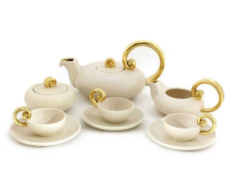 A Vallauris earthenware tea service,1940s, designed by Marcel Giraud, of squat form with gilt scroll handles, comprising: tea