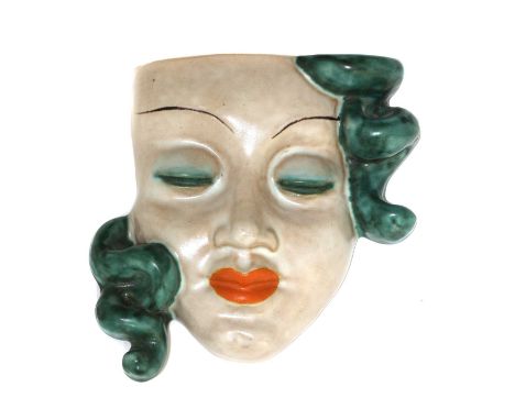 A rare Goldscheider pottery wall pocket,no. 6086A, modelled with turquoise hair and eyelids and red lips, printed and incised