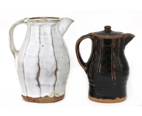 *Jim Malone (b.1946),two stoneware coffee jugs and covers, one with faceted sides and a mushroom glaze, impressed with artist