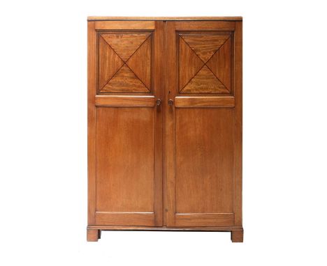 An Heal &amp; Son mahogany and inlaid cabinet,with panelled doors, the top panels with a cross inlay, cedar lined with five d