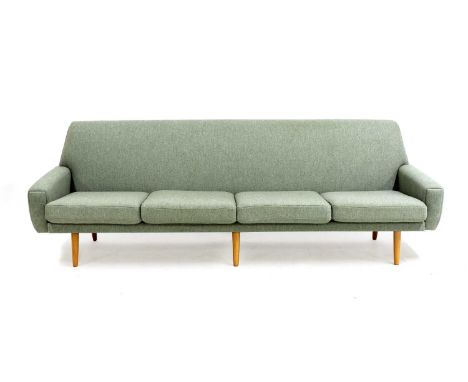 A Danish four-seater sofa,1960s, on turned tapering beech legs, upholstered in mint-green wool fabric, with four loose cushio