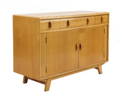 An Heal's oak sideboard, 1950s, with four drawers, each with an octagonal handle, over a pair of doors opening on to shelving