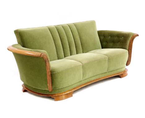 A Danish Art Deco sofa,1930s, with an oak frame, the front with carved detail, upholstered in green cotton velour, with a ree