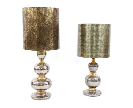 A near pair of silvered and gilt lamps,both of stacked bulbous form, each with a drum lampshade with an églomisé glass effect