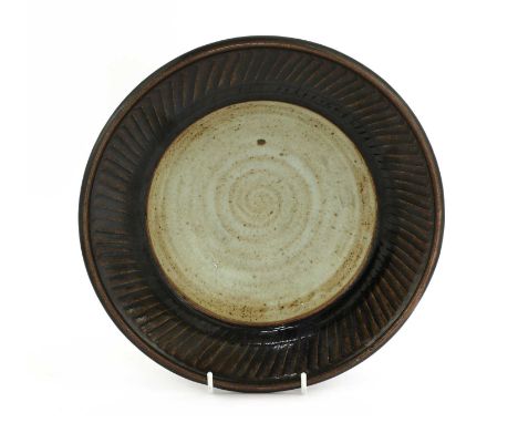 *David Leach (1920-2005),a mingei-style bowl, the rim with incised spiralling decoration with a tenmoku glaze, the bowl with 