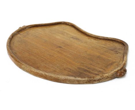 A Robert 'Mouseman' Thompson oak tray,of kidney shape, with an adzed top and a low rim, with the carved signature mouse each 
