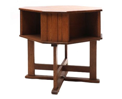 An Arts and Crafts oak octagonal book table, with a shelf below, raised on a double 'X' shaped stretcher,60cm diameter64cm hi