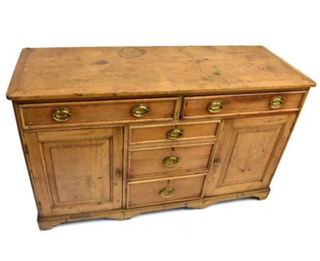 A late George III Lincolnshire pine dresser, with moulded top above two drawers, three further central drawers flanked by cup
