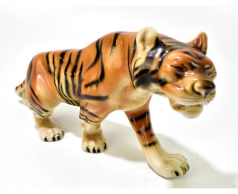 ROYAL DUX; a ceramic figure of a stalking tiger, embossed pink triangle mark and numbered 312 to base, length 42cm.Additional