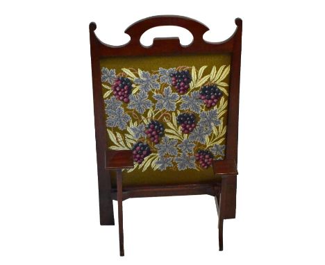 An Arts &amp; Crafts firescreen with shaped uprights and grape and vine embroidered panel, numbered 130 to lower front, 84 x 