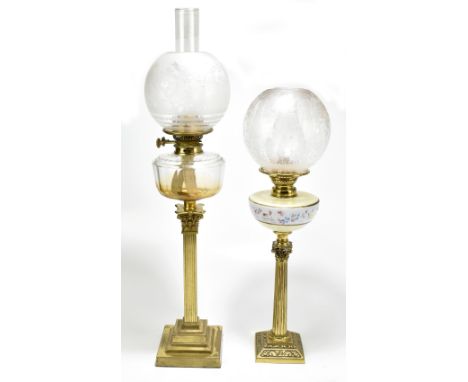 A late 19th century oil lamp, with frosted shade and clear glass reservoir, raised on Corinthian column base, height 79cm, to