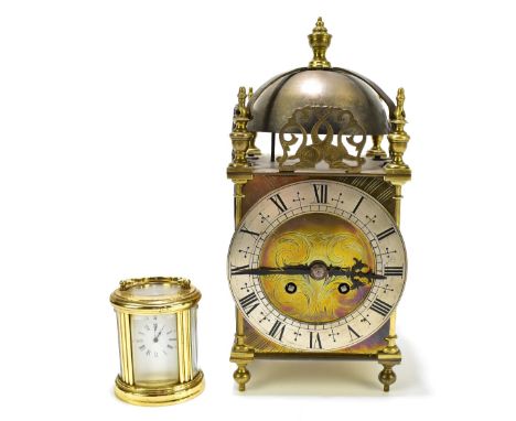 A French reproduction brass cased lantern clock with applied detail depicting intertwined fish and applied silvered dial, hei