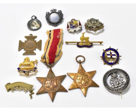A group of assorted medals and brooches including the Africa Star, The 1939-45 Star etc.Additional InformationNumerous losses