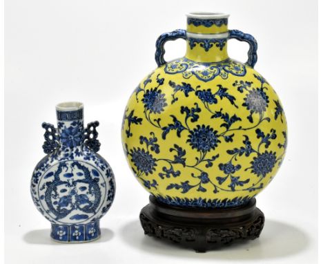 A late 19th century Chinese blue and white porcelain twin handled moon flask painted with four-claw dragons chasing the Pearl