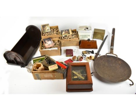 An assortment of collectors' items to include various cigarette cards, Bakelite book trough, WWI bayonet, bed warmer, etc.Add