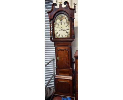 An early 19th century oak, mahogany and inlaid eight day longcase clock, the arched painted enamel dial with moon phase above