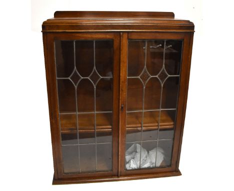 An early 20th century oak bookcase section from a bureau bookcase, with two leaded glazed doors enclosing adjustable shelves,