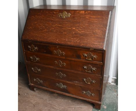 A Georgian oak bureau, the fall front enclosing a fitted interior above four long drawers on bracket feet, width 92cm.