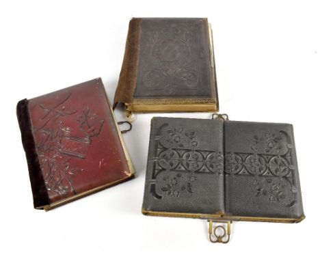 Three Victorian photograph albums containing portrait sepia photographs, some annotated (one album binding af) (3).Additional