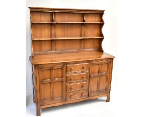 ERCOL; medium elm dresser with plate rack above four central drawers flanked by doors, width 145cm, height 169cm.