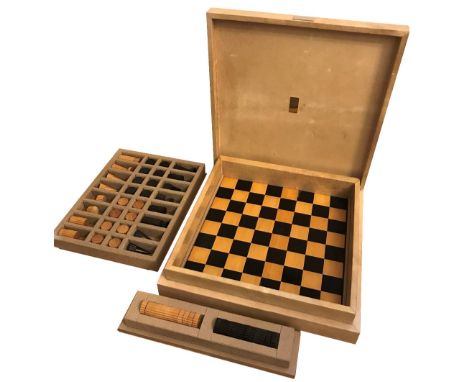 GHISO FOR DUNHILL; an Art Deco carved boxwood and ebony chess and draughts set with double sided wooden board.