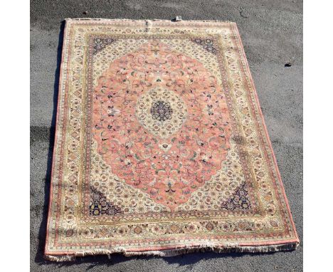 CHAKHARI; a large Indian hand knotted wool pile carpet with stylised foliate motifs on cream ground with red, mustard and tea