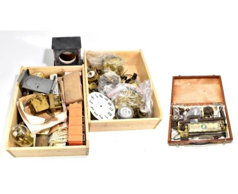A group of clock movements, components, tools including a lathe and further accessories, also a brass Anniversary clock house