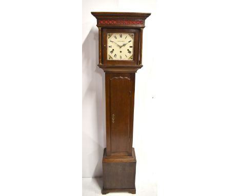 A reproduction oak cased longcase clock of small proportions with blind fret detail to the hood, white painted dial set with 