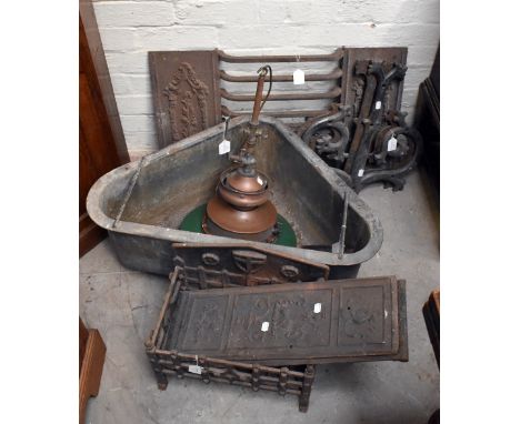 A group of cast iron fireplace furniture including grates, a pair of panels with relief Neo-Classical style decoration and a 