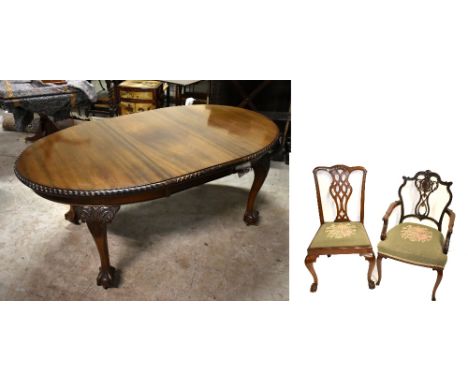 An early 20th century mahogany oval extending dining table with rope twist border, single additional leaf and knee carved cab