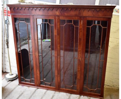 A reproduction mahogany bookcase with moulded cornice above four astragal glazed doors and a base of four cupboard doors rais