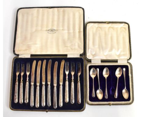 WILLIAM HUTTON &amp; SONS; a cased set of six George V hallmarked silver handled fruit knives and forks, Sheffield 1917, and 