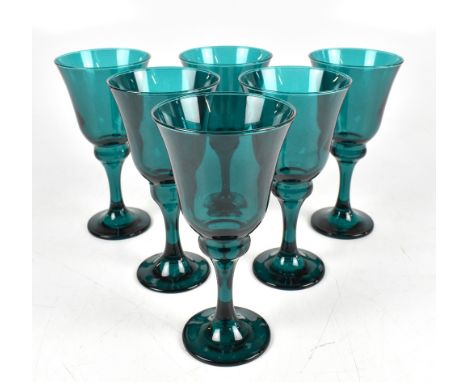 A set of six large Victorian green glass wine glasses on spreading circular feet, height of each 18.5cm.Additional Informatio