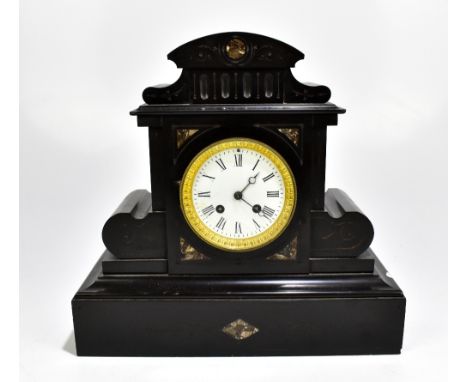 A late 19th century black slate eight day mantel clock of architectural form, the enamelled dial set with Roman numerals (dia