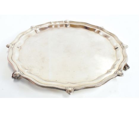 S BLANCKENSEE &amp; SON; a George V&nbsp;hallmarked silver salver with cast beaded rim and open shells, raised on three ball 