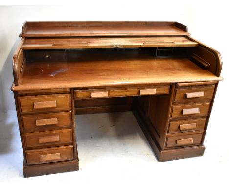 An early 20th century mahogany roll top desk, the shallow tambour top above twin pedestals, width 152cm.Additional Informatio