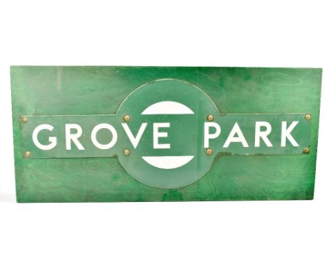 A 'Grove Park' railway enamel sign applied on a green painted wooden board, the board 40.5 x 92cm.Additional InformationThe s