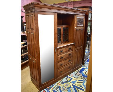 A late Victorian ash combination wardrobe with central twin leaded glazed doors enclosing single shelf above four short drawe